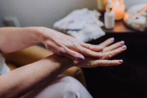 What Causes Dry Skin on Hands? 4 Big Reasons A detailed view of hands applying lotion for skincare, showcasing self-care and beauty routine.