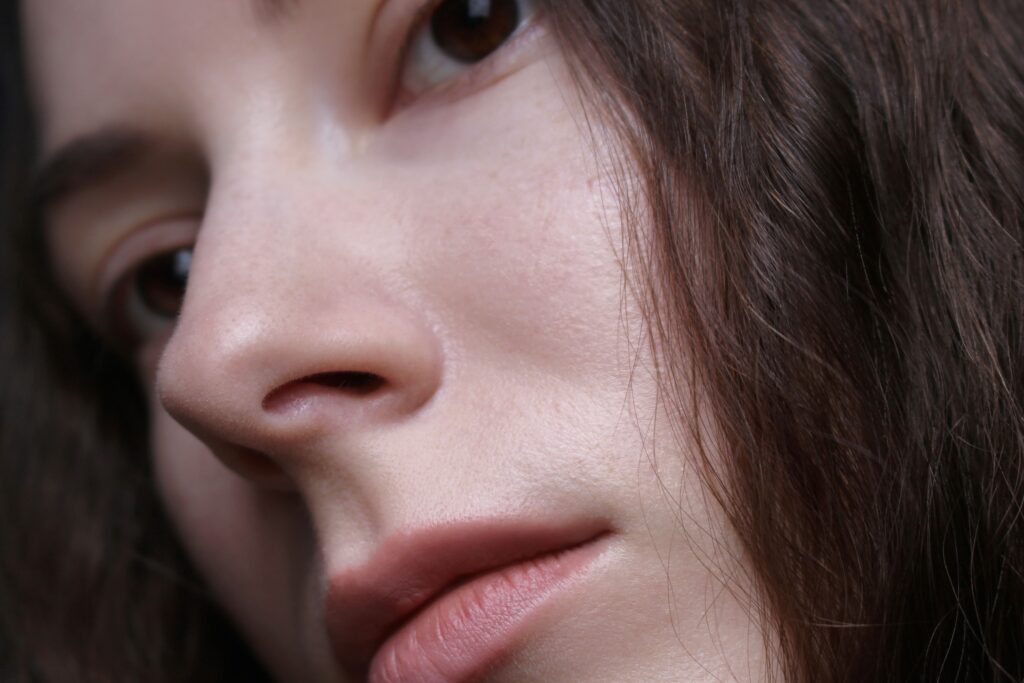 Is a Cleansing Oil Good For Oily Skin? Detailed close-up portrait featuring the natural beauty of a woman's face and hair.