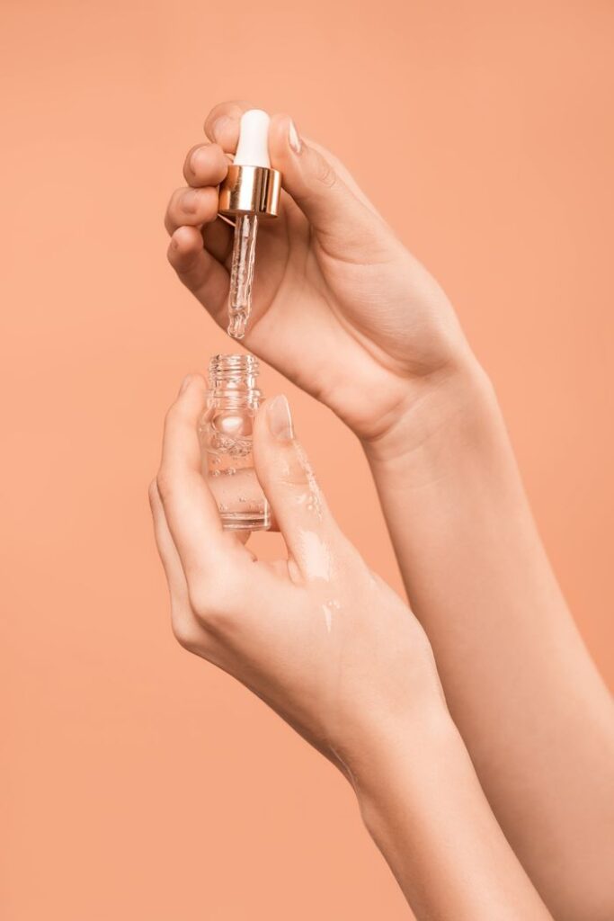 pexels photo 3762882 3762882 Close-up of hands using a dropper to apply skincare serum, ideal for health and beauty content.