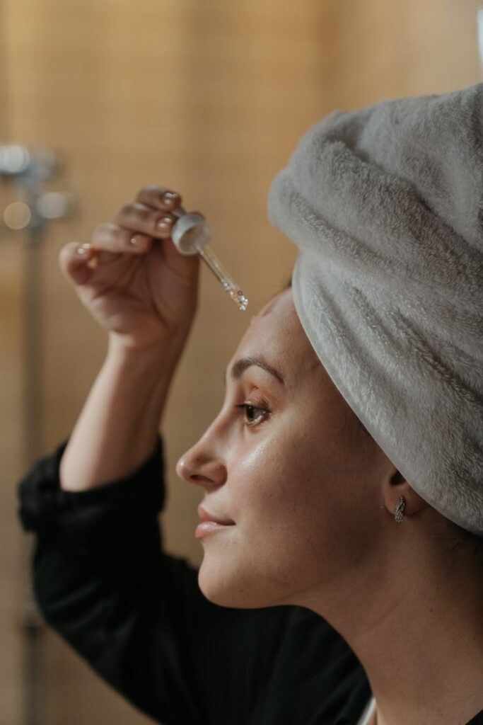 pexels photo 4612159 4612159 1 Close-up side view of a woman applying skincare serum with a dropper, promoting beauty routine.