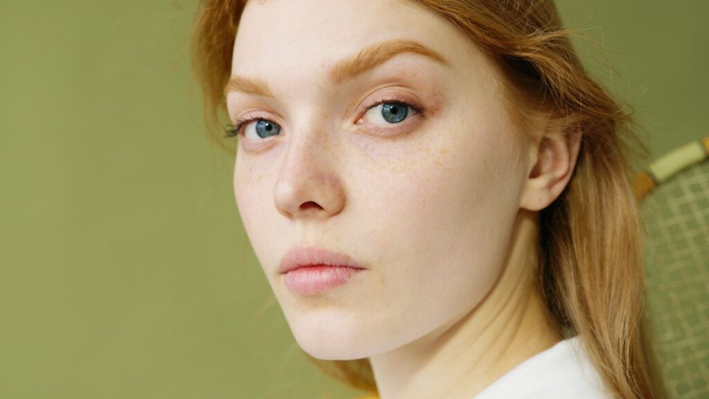 pexels photo 7648163 7648163 Detailed close-up portrait capturing a young woman's natural beauty and blue eyes.