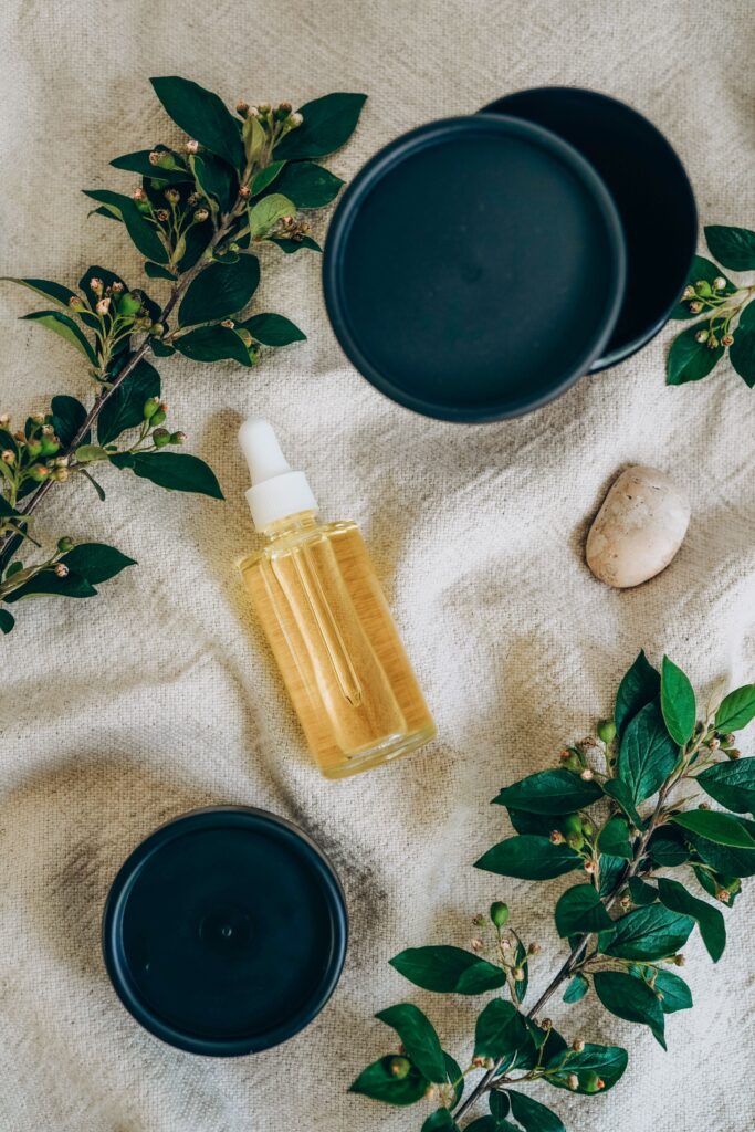 pexels photo 8490182 8490182 Glass bottle of yellow serum surrounded by green leaves on fabric, showcasing botanical skincare.