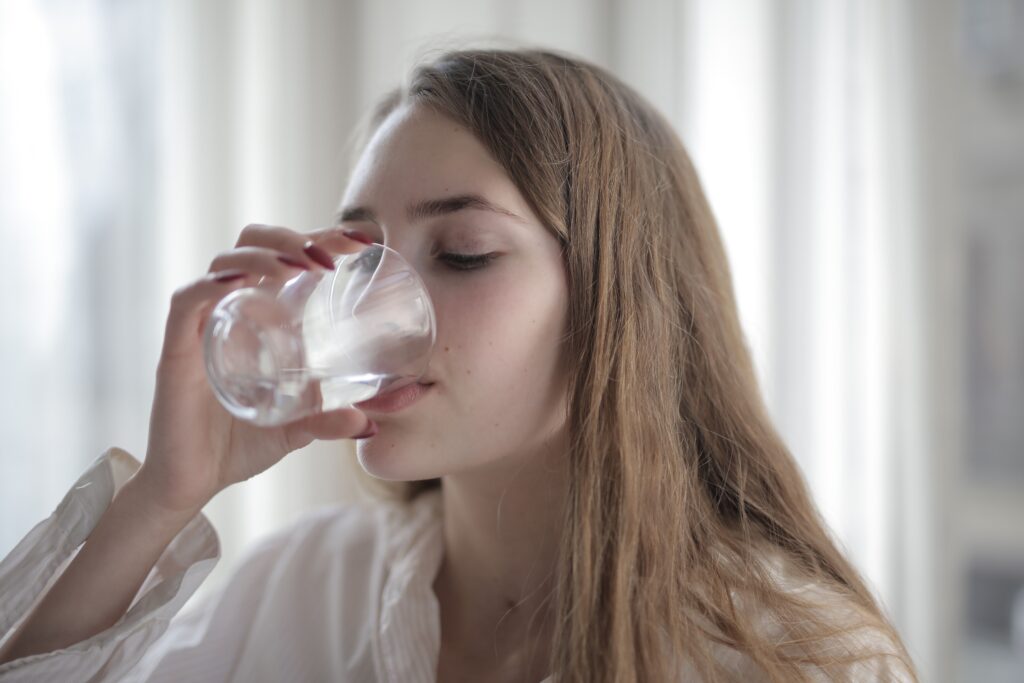 pexels photo 3794165 3794165 A woman enjoying a refreshing glass of water indoors during the day.