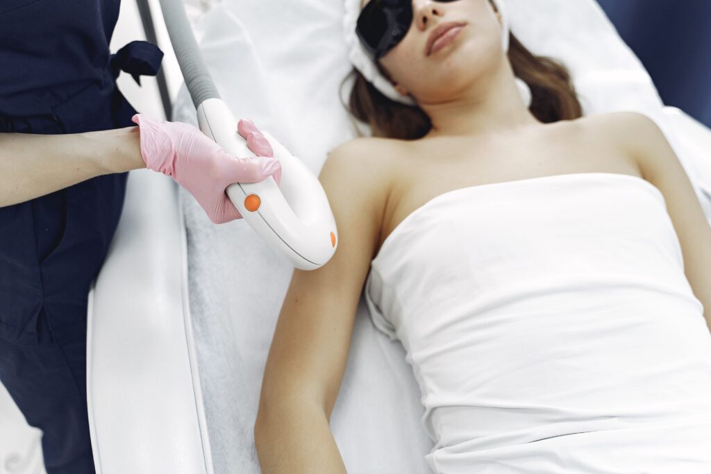 pexels-photo-3985354-3985354 From above of unrecognizable cosmetologist in uniform and latex gloves using modern equipment for cosmetic services in contemporary salon